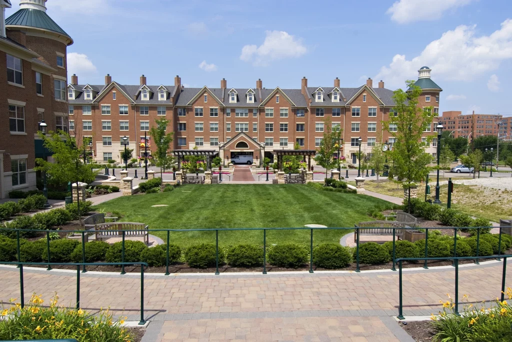 Exterior of brick apartment building with landscaping | The village at Stetson Square in Corryville, Cincinnati, Ohio